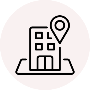 Black icon of building with a location point